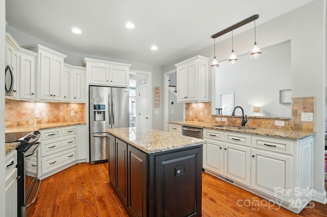 7006 Nesbit Rd, Waxhaw, NC 28173 - kitchen with a sink, stainless steel appliances, white cabinets, tasteful backsplash, and recessed lighting