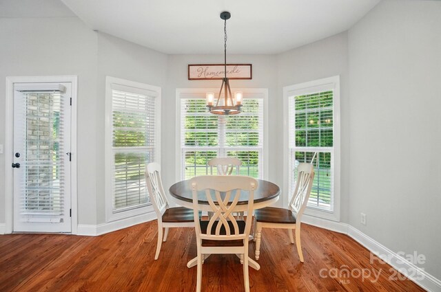 7006 Nesbit Rd, Waxhaw, NC 28173 - dining space with a chandelier, wood finished floors, and baseboards