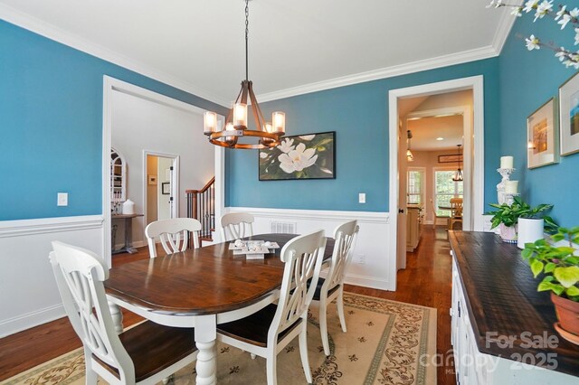 7006 Nesbit Rd, Waxhaw, NC 28173 - dining room featuring a chandelier, wood finished floors, wainscoting, and crown molding