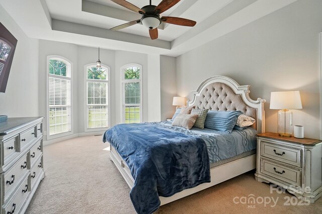7006 Nesbit Rd, Waxhaw, NC 28173 - bedroom with light colored carpet, a raised ceiling, and a ceiling fan