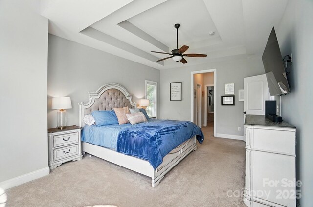 7006 Nesbit Rd, Waxhaw, NC 28173 - bedroom featuring a raised ceiling, light carpet, baseboards, and ceiling fan