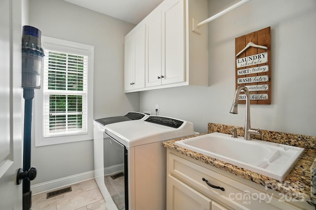 7006 Nesbit Rd, Waxhaw, NC 28173 - washroom with washer and dryer, cabinet space, baseboards, and light tile patterned floors