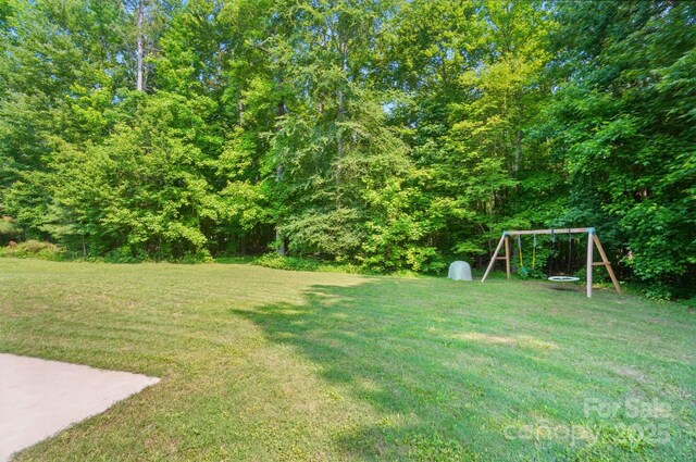 7006 Nesbit Rd, Waxhaw, NC 28173 - view of green lawn featuring a playground and a wooded view