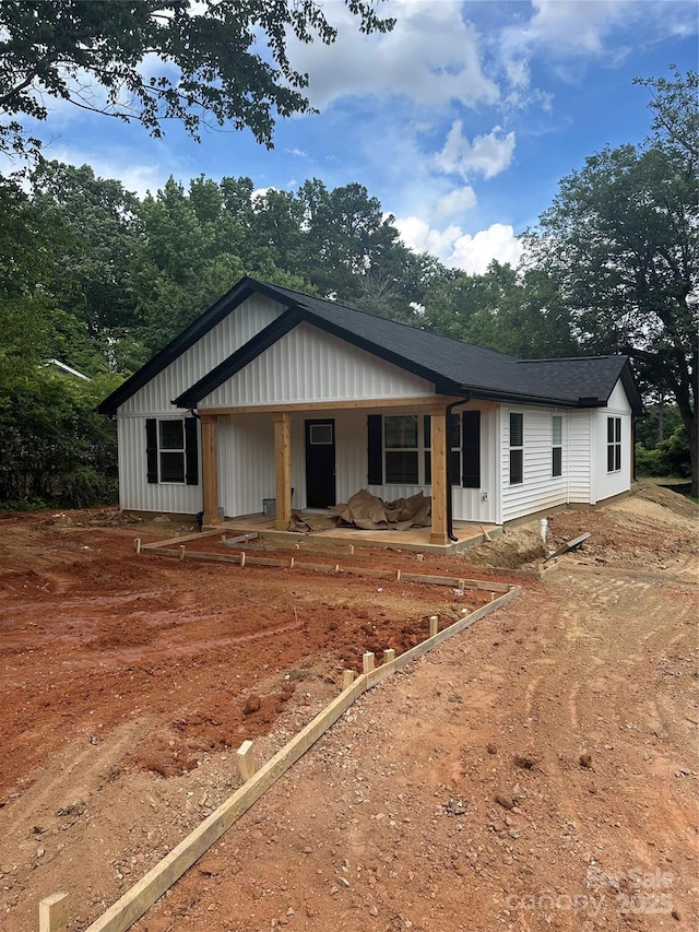 807 S Bostian St, China Grove, NC 28023 - view of front of property with covered porch and board and batten siding