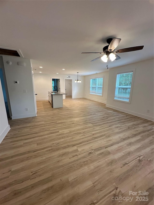 807 S Bostian St, China Grove, NC 28023 - unfurnished living room featuring a ceiling fan, light wood-style flooring, and recessed lighting