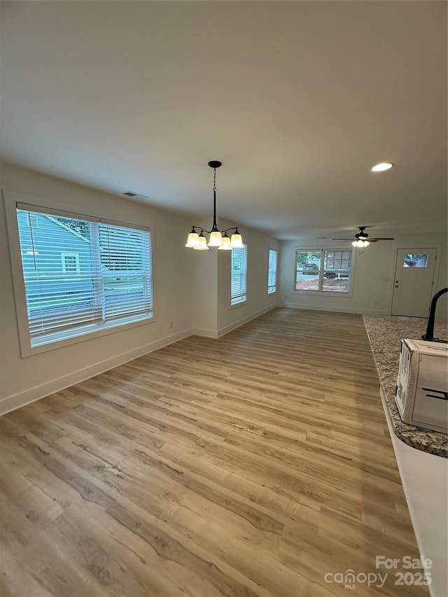 807 S Bostian St, China Grove, NC 28023 - unfurnished dining area featuring a chandelier, light wood-style floors, recessed lighting, and ceiling fan