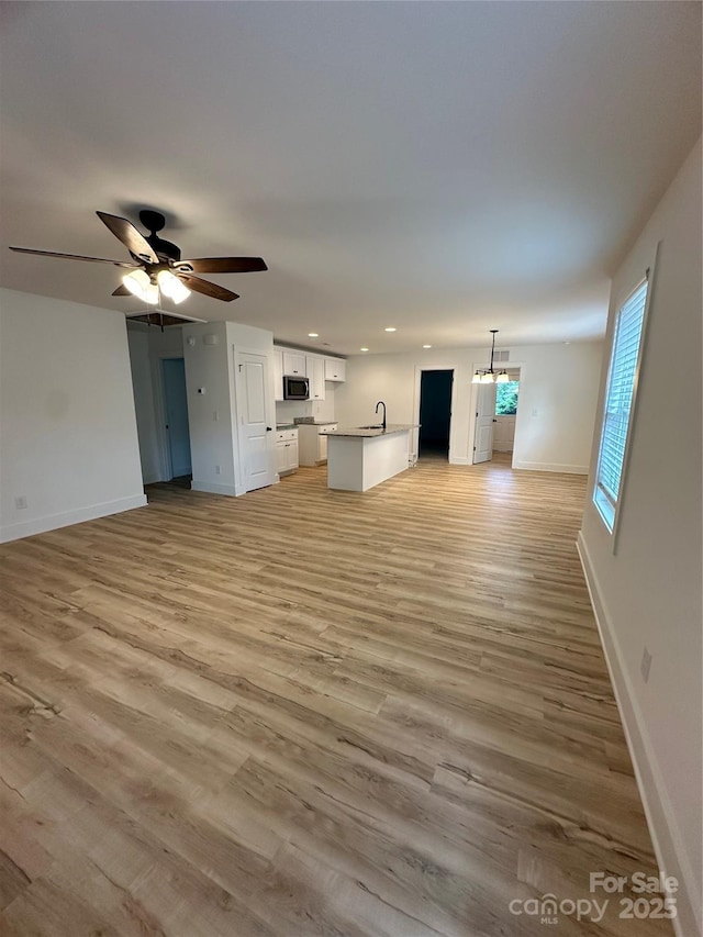 807 S Bostian St, China Grove, NC 28023 - unfurnished living room featuring ceiling fan, light wood-style floors, and recessed lighting