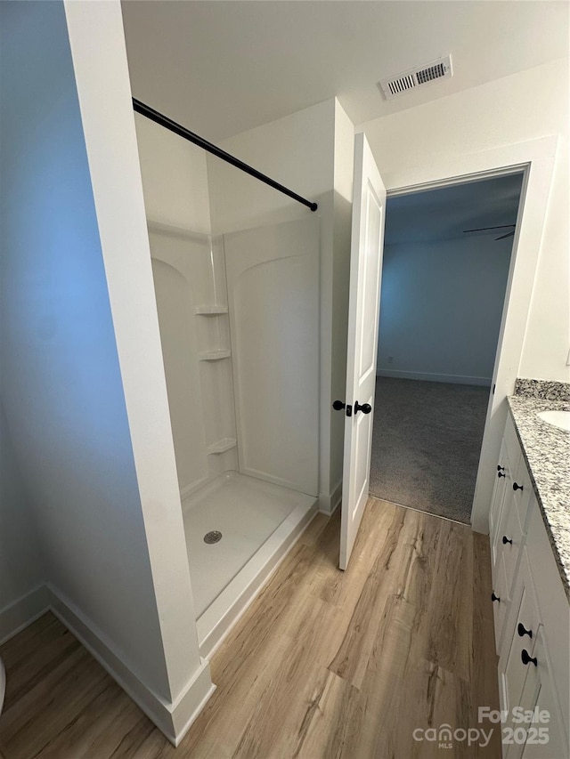 807 S Bostian St, China Grove, NC 28023 - full bathroom with vanity, wood finished floors, and a walk in shower