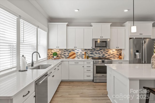 1036 Riverwalk Pkwy, Rock Hill, SC 29730 - kitchen with stainless steel appliances, a sink, light countertops, white cabinets, and recessed lighting