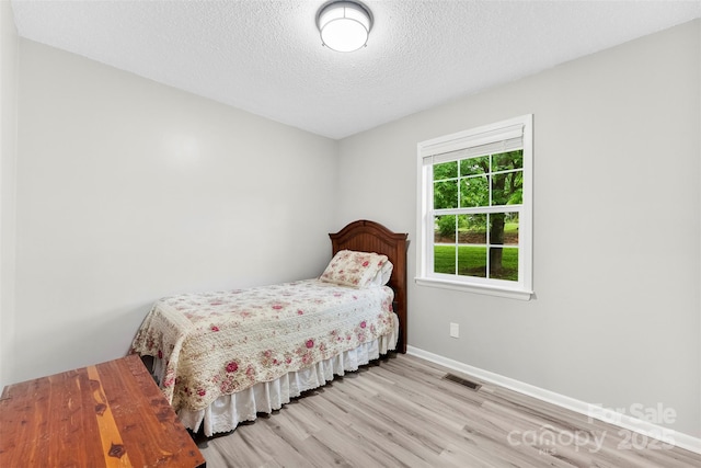 103A N Tracy St, Kings Mountain, NC 28086 - bedroom with wood finished floors, baseboards, and a textured ceiling