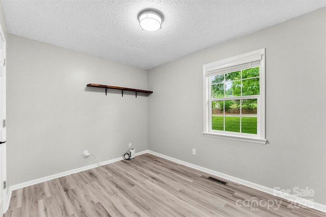 103A N Tracy St, Kings Mountain, NC 28086 - spare room with light wood-style floors, a textured ceiling, and baseboards