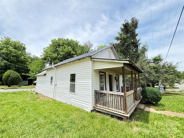 502 E Main St, Cleveland, NC 27013 - view of home's exterior with covered porch, a lawn, and metal roof