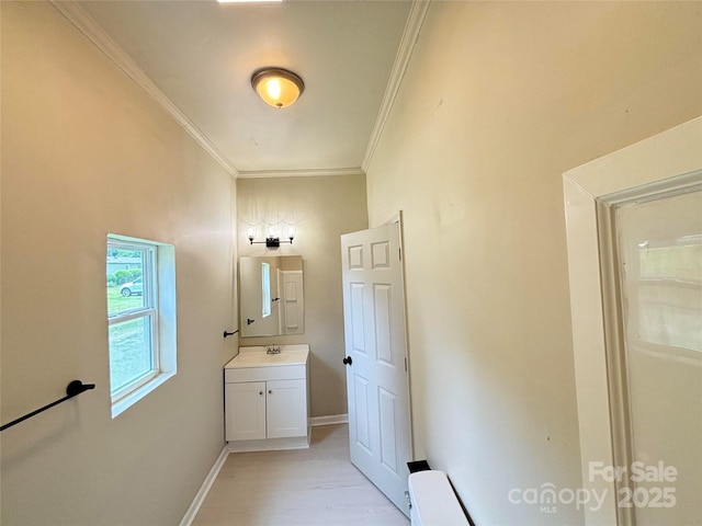 502 E Main St, Cleveland, NC 27013 - bathroom featuring crown molding, vanity, baseboards, and wood finished floors