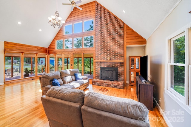6350 Mount Pleasant Rd S, Concord, NC 28025 - living area featuring high vaulted ceiling, healthy amount of natural light, light wood-type flooring, a brick fireplace, and a chandelier