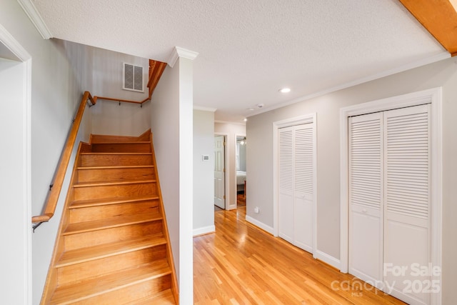 6350 Mount Pleasant Rd S, Concord, NC 28025 - stairway with crown molding, a textured ceiling, wood finished floors, recessed lighting, and baseboards