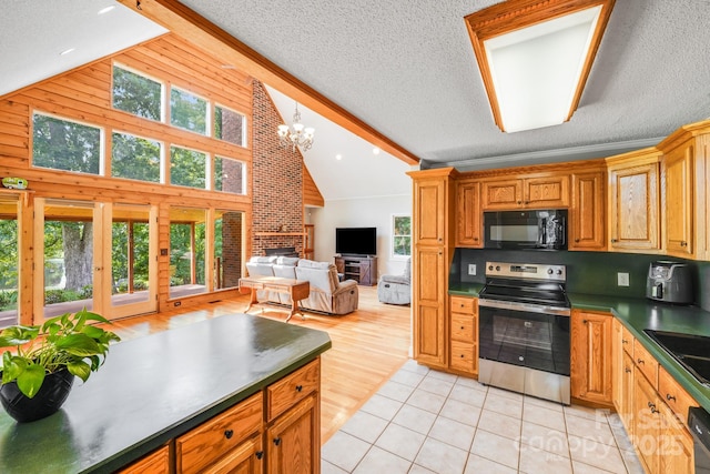 6350 Mount Pleasant Rd S, Concord, NC 28025 - kitchen featuring electric range, black microwave, dark countertops, open floor plan, and high vaulted ceiling