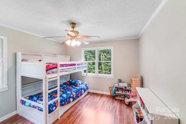 6350 Mount Pleasant Rd S, Concord, NC 28025 - bedroom featuring wood finished floors, ornamental molding, a textured ceiling, baseboards, and ceiling fan