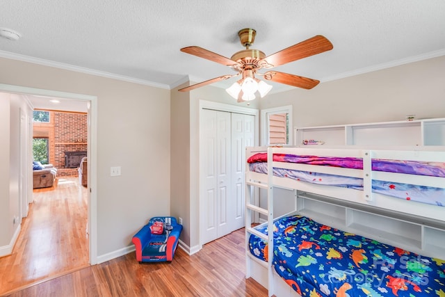 6350 Mount Pleasant Rd S, Concord, NC 28025 - bedroom with a textured ceiling, wood finished floors, crown molding, a closet, and baseboards