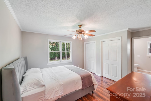 6350 Mount Pleasant Rd S, Concord, NC 28025 - bedroom featuring two closets, wood finished floors, a textured ceiling, crown molding, and ceiling fan
