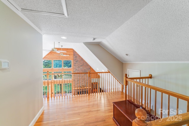 6350 Mount Pleasant Rd S, Concord, NC 28025 - hall featuring a textured ceiling, wood finished floors, ornamental molding, an upstairs landing, and lofted ceiling