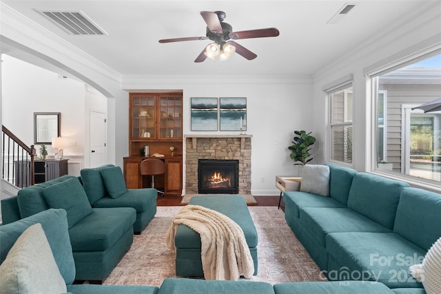 4500 Carrington Dr, Lancaster, SC 29720 - living room featuring a ceiling fan, a fireplace, ornamental molding, arched walkways, and wood finished floors