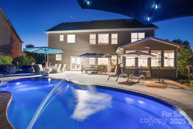 4500 Carrington Dr, Lancaster, SC 29720 - back of house at twilight featuring a patio area and an outdoor pool