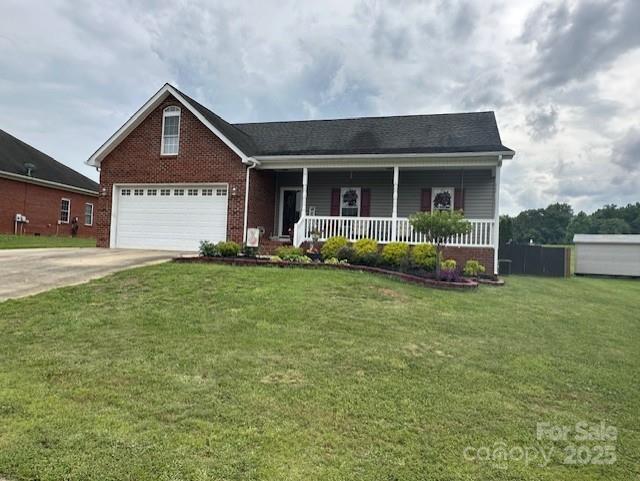 111 Brookview Dr, Shelby, NC 28152 - view of front of house featuring covered porch, driveway, brick siding, a front lawn, and a garage