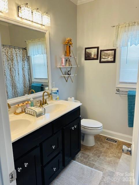 111 Brookview Dr, Shelby, NC 28152 - full bath with double vanity, toilet, baseboards, ornamental molding, and curtained shower