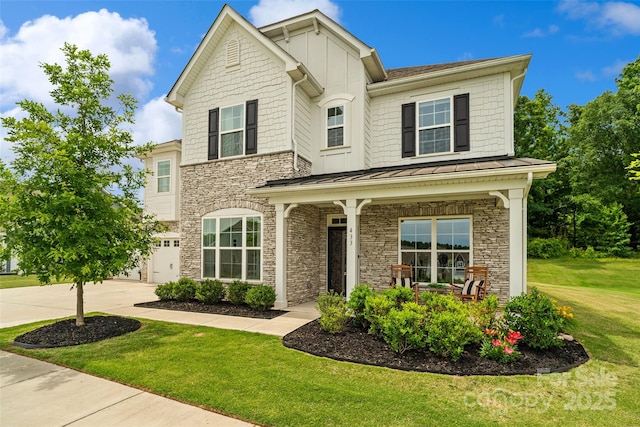 433 Sinaloa St, Waxhaw, NC 28173 - craftsman inspired home featuring stone siding, concrete driveway, a front lawn, a standing seam roof, and covered porch