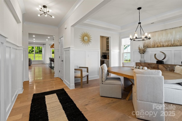 433 Sinaloa St, Waxhaw, NC 28173 - dining area with a chandelier, a decorative wall, ornamental molding, and light wood-style floors