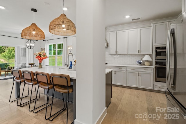 433 Sinaloa St, Waxhaw, NC 28173 - kitchen with stainless steel appliances, plenty of natural light, a breakfast bar, backsplash, and recessed lighting
