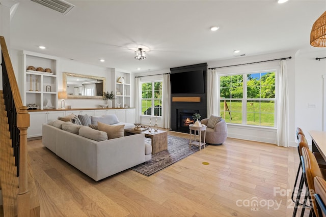 433 Sinaloa St, Waxhaw, NC 28173 - living area featuring a fireplace, light wood-style flooring, recessed lighting, plenty of natural light, and baseboards