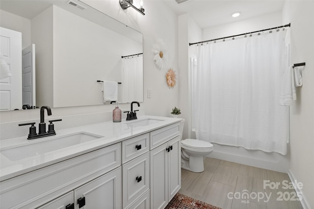 433 Sinaloa St, Waxhaw, NC 28173 - full bathroom with double vanity, toilet, shower / bath combo with shower curtain, and recessed lighting