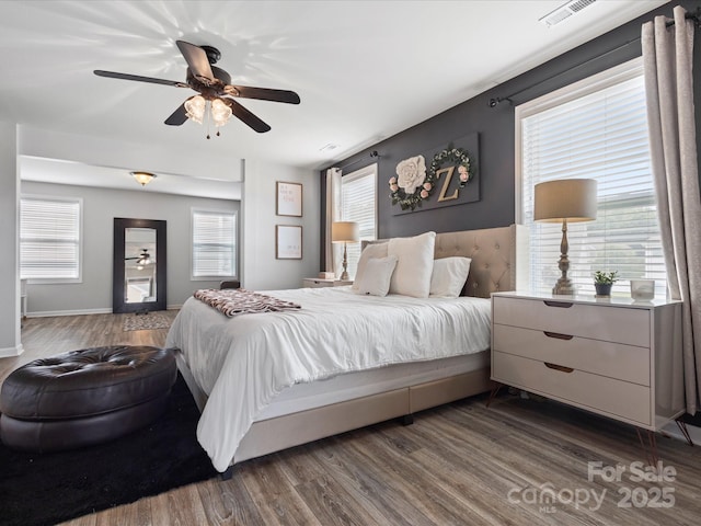 1810 Kerwick Ct, Lancaster, SC 29720 - bedroom featuring dark wood-style flooring, multiple windows, ceiling fan, and baseboards