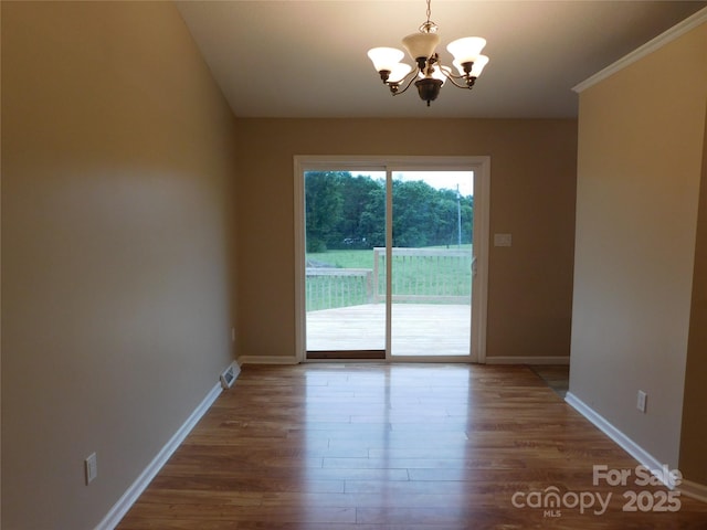 3001 Austin Chaney Rd, Monroe, NC 28110 - spare room with a chandelier, wood finished floors, and baseboards