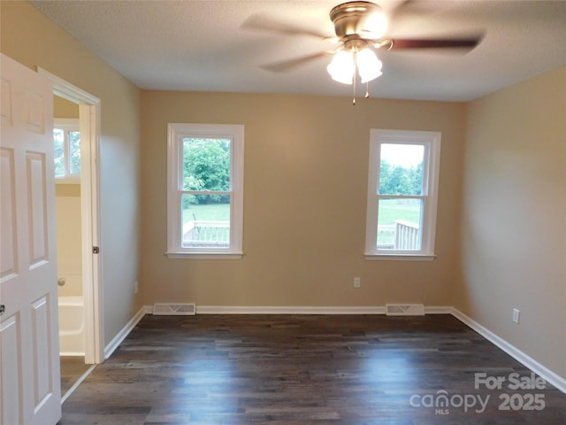 3001 Austin Chaney Rd, Monroe, NC 28110 - empty room featuring healthy amount of natural light, dark wood-style flooring, a ceiling fan, and baseboards