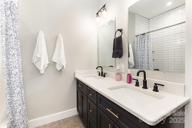 5215 Star Magnolia Ct, Clover, SC 29710 - bathroom with double vanity, baseboards, tiled shower, and tile patterned flooring