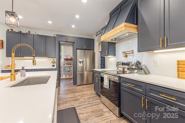 5215 Star Magnolia Ct, Clover, SC 29710 - kitchen featuring stainless steel appliances, custom range hood, a sink, tasteful backsplash, and light countertops