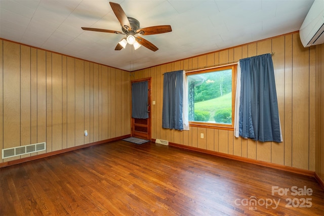 1788 Blue Rock Rd, Burnsville, NC 28714 - unfurnished room with a wall mounted air conditioner, wood finished floors, ceiling fan, baseboards, and wooden walls