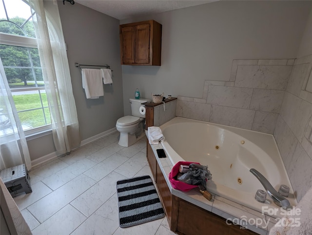 936 New Camp Creek Church Rd Unit 11, Kings Mountain, NC 28086 - bathroom with a whirlpool tub, baseboards, toilet, and marble look tiles
