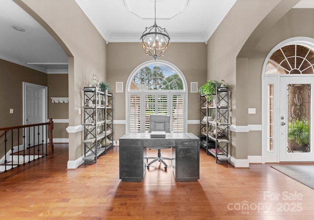 7412 Sahalee Dr, Denver, NC 28037 - office area with arched walkways, a chandelier, wood finished floors, ornamental molding, and baseboards