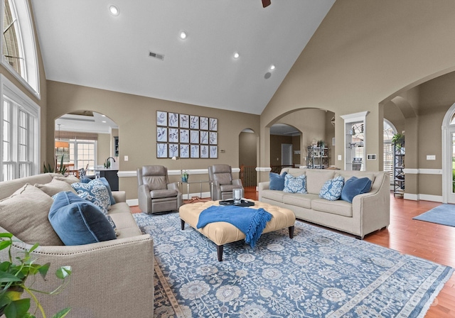 7412 Sahalee Dr, Denver, NC 28037 - living area featuring high vaulted ceiling, arched walkways, wood finished floors, recessed lighting, and baseboards