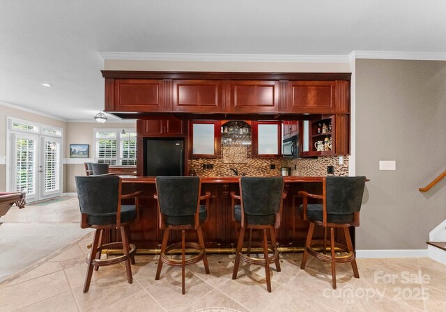 7412 Sahalee Dr, Denver, NC 28037 - indoor wet bar featuring black appliances, crown molding, backsplash, french doors, and light tile patterned floors