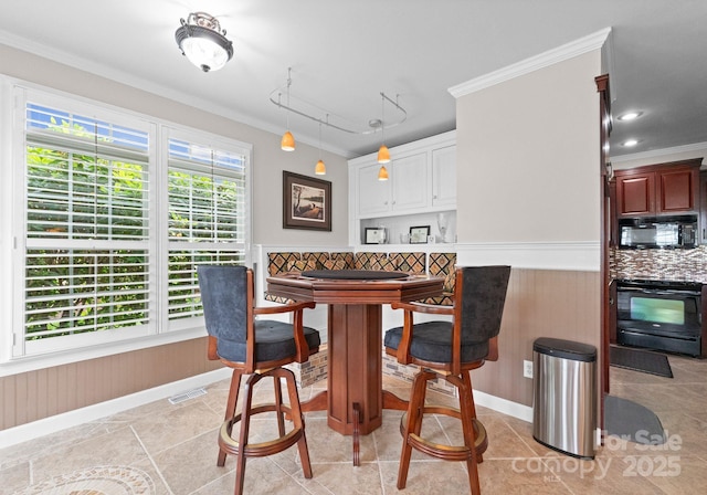 7412 Sahalee Dr, Denver, NC 28037 - dining room with ornamental molding, baseboards, light tile patterned floors, and a wainscoted wall