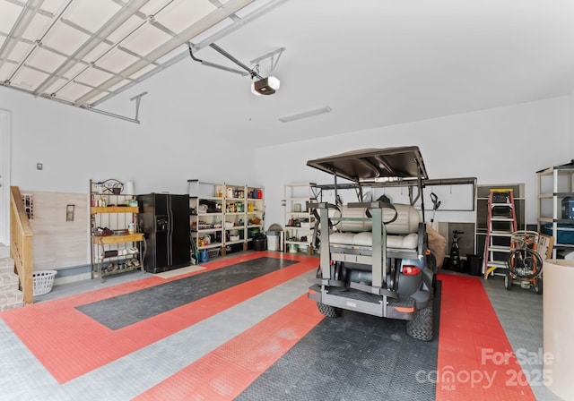 7412 Sahalee Dr, Denver, NC 28037 - garage with black refrigerator with ice dispenser and a garage door opener