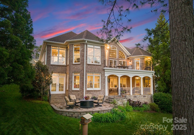 7412 Sahalee Dr, Denver, NC 28037 - back of property featuring french doors, a lawn, a fire pit, and a patio area