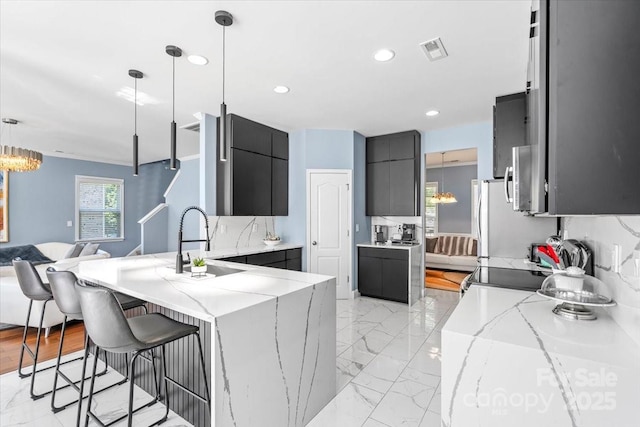 2213 Iron Works Dr, Clover, SC 29710 - kitchen with modern cabinets, open floor plan, a breakfast bar, a peninsula, and light stone countertops