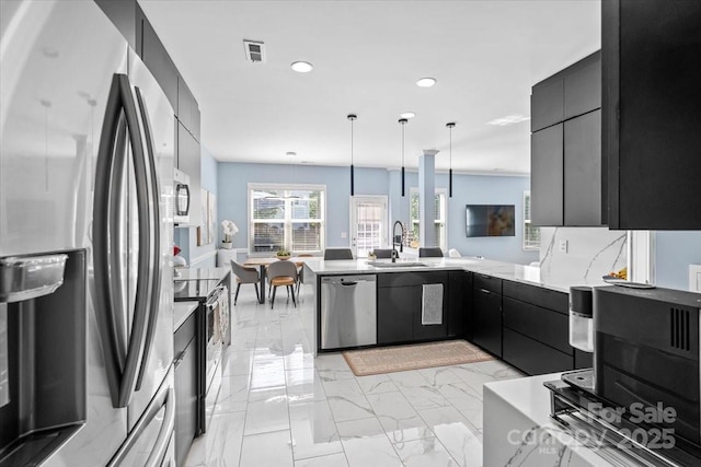 2213 Iron Works Dr, Clover, SC 29710 - kitchen with appliances with stainless steel finishes, dark cabinetry, modern cabinets, light marble finish floors, and recessed lighting