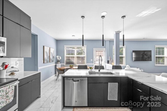 2213 Iron Works Dr, Clover, SC 29710 - kitchen with appliances with stainless steel finishes, open floor plan, light marble finish floors, and healthy amount of natural light