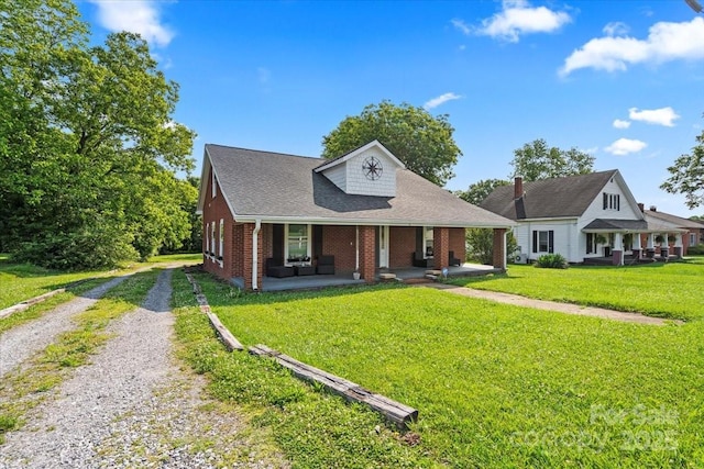 85 Ruritan Park Rd, Stony Point, NC 28678 - view of front of home featuring a porch, driveway, brick siding, a front lawn, and roof with shingles
